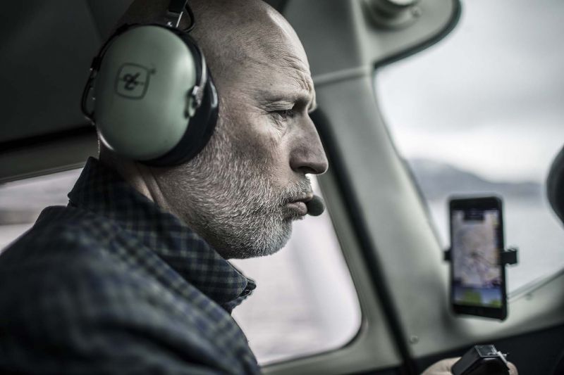 Lasse Kjius in the cockpit of a plane, wearing a headset