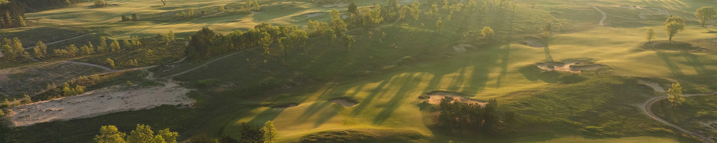 The sun dawns on a bird's eye view of the rolling fairway at Sand Valley.