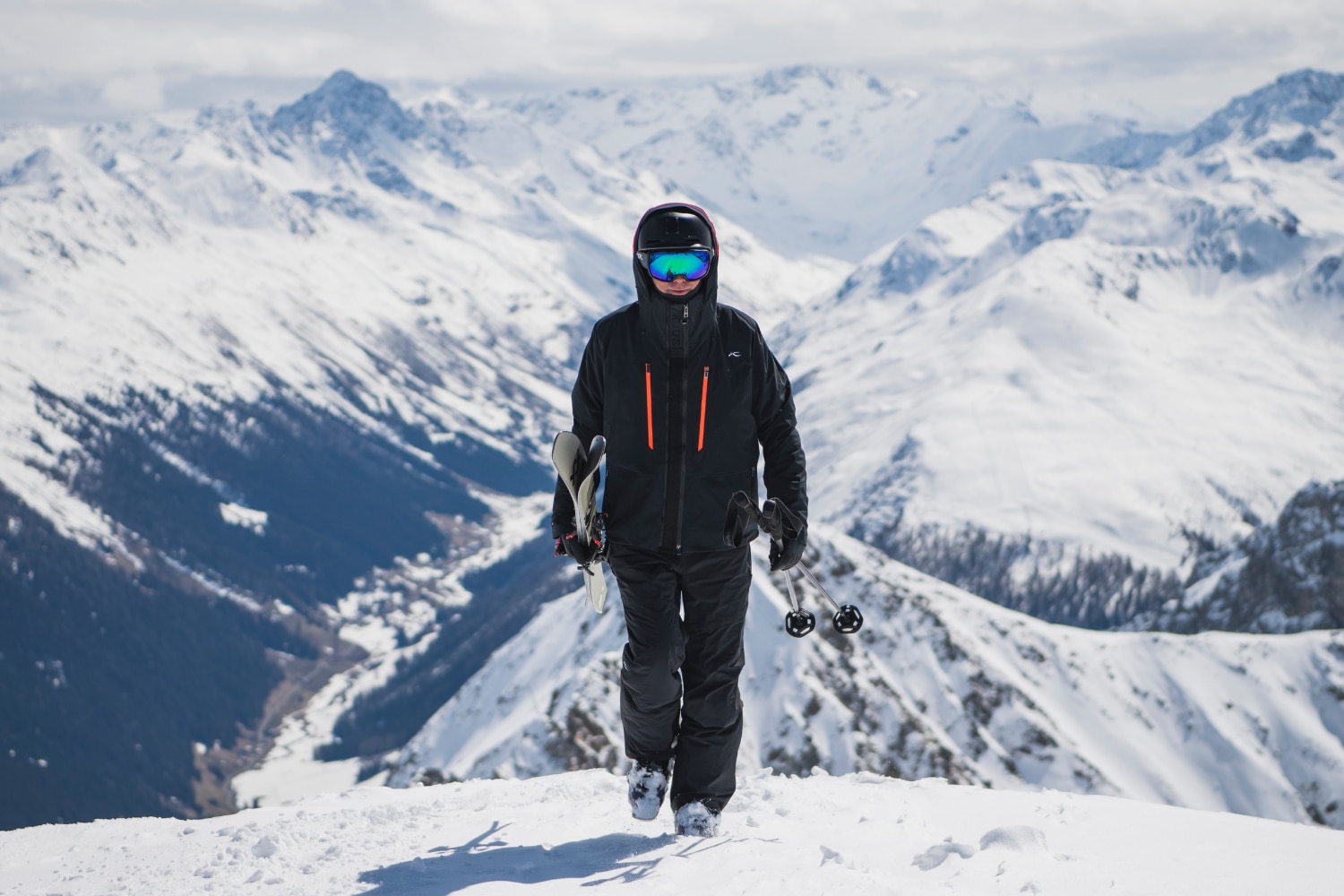 A man wearing a light blue KJUS long-sleeve polo.