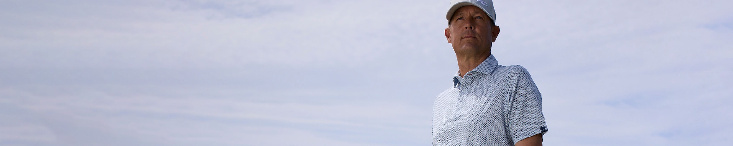 Man wearing KJUS hollow pima cotton polo.