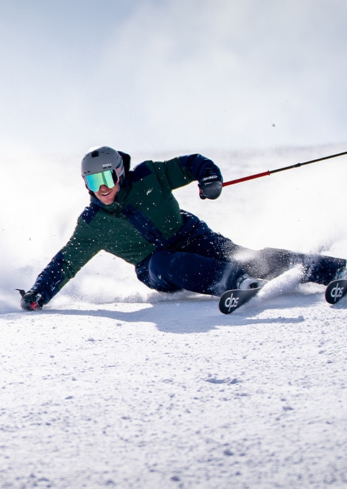 3 colorways of the KJUS Ligety HexAir Jacket shown in blue, navy, and green/blue.