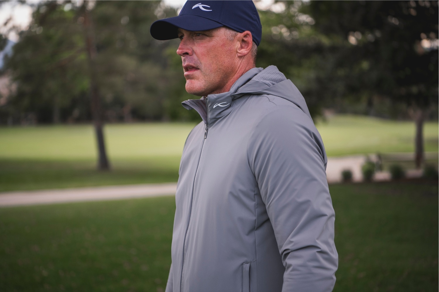 A man wearing a grey KJUS jacket.