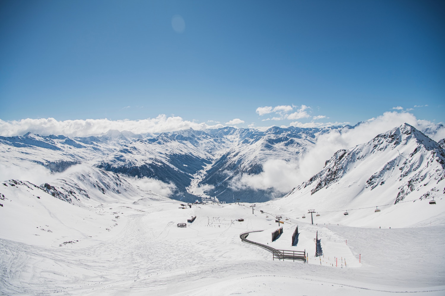A snow-covered mountain range with a ski lift.